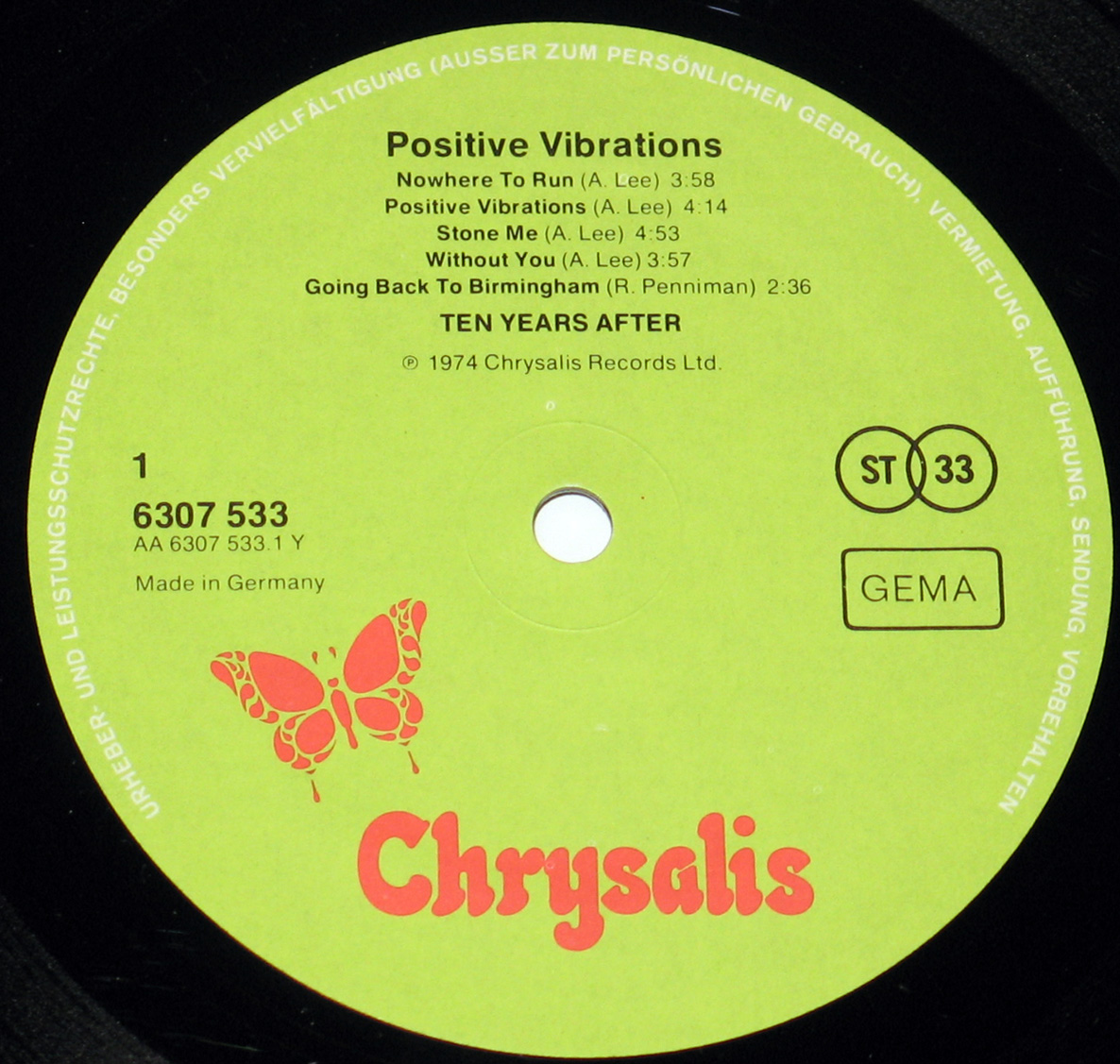 Close-up of the vinyl record label for 'Positive Vibrations' by Ten Years After, featuring a bright green background, red Chrysalis logo with a butterfly, tracklist, and record details in black text.